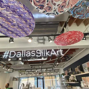 Inside the studio. Sample parasols hanging from the ceiling.