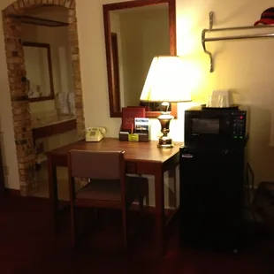 Desk, chair, fridge, microwave and a WiFi that can be a bit spotty but is included in a reasonable rate.
