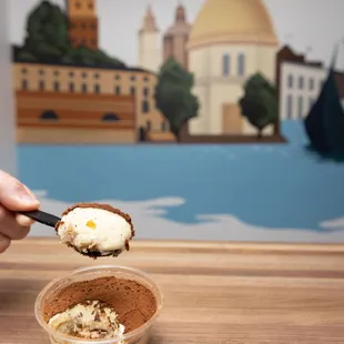 a hand holding a scoop of ice cream