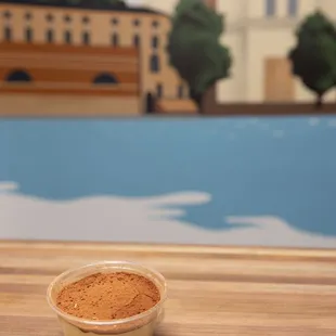a bowl of groundnuts on a wooden table