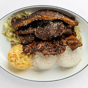 Aloha Mix plate! A mouthwatering combination of Calbi Ribs, Teriyaki Beef, and Teriyaki Chicken, served with macaroni salad and rice.