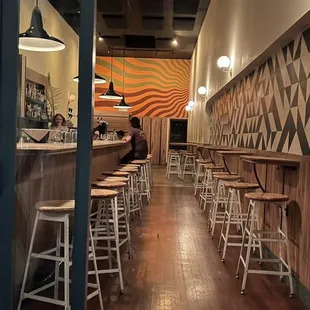 a view of a bar with stools