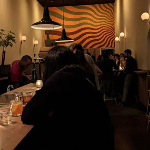 a group of people sitting at a bar