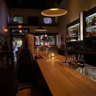 a woman sitting at a bar