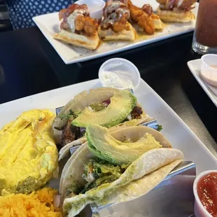 Breakfast tacos with 2 eggs any way + Chicken &amp; waffles in background