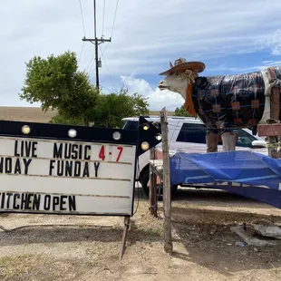 Sign and cow out front