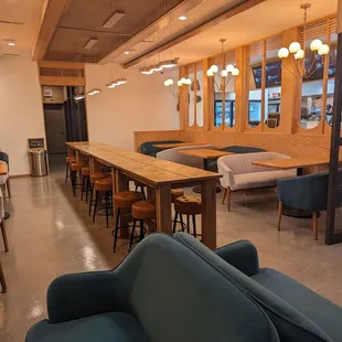 a restaurant with a long table and blue chairs