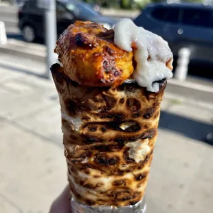 a hand holding an ice cream cone