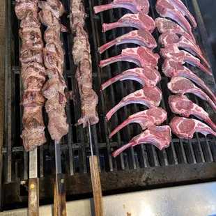 steaks and skewers on a grill