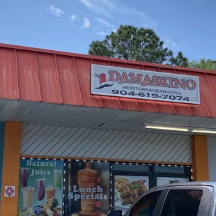 a car parked in front of a restaurant