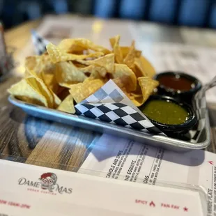 a plate of chips and condiments