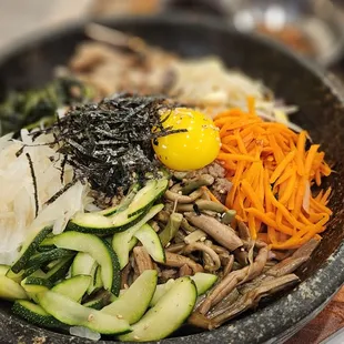 Solsot Bibimbab $20.95: Rice topped w/ 7 Namul, Beef, Egg Fry in Hot Stone Pot
