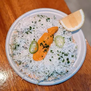 Uni tostada Caesar with romaine, parmigiano.