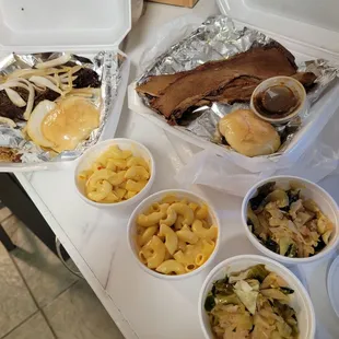 Left: Slow Smoked Ribeye topped with onions.  Right: Brisket, both with the Mac n cheese and cabbage as sides.