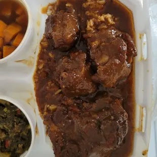 Smothered Ox tails over rice, corn bread, greens and yams