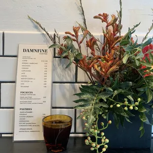 a menu and a vase of flowers