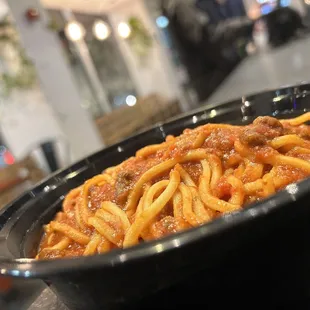 a black bowl of pasta