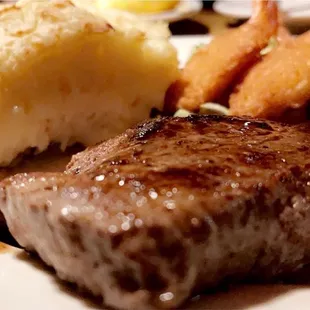 Top sirloin with breaded prawns and baked potato.