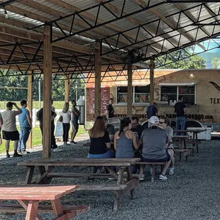 people sitting at picnic tables