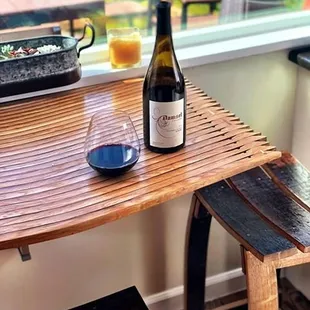 Damsel Syrah perched on a table and stool made from Damsel Syrah barrels!