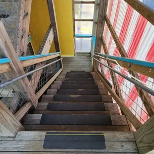 Stairs down from upstairs where bathrooms are.