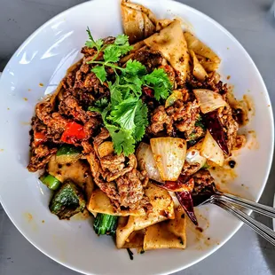 CUMIN LAMB HAND-RIPPED NOODLES | 乾拌孜然羊手扯麵: our signature cumin lamb dish served on top of hand ripped noodles - spice: 3/5. $14.75