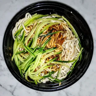 COLD SESAME NOODLES | 芝麻涼麵 our lo-mein style noodles tossed with sesame paste, and soy sauce, topped with cucumbers. $9.25