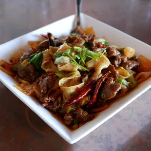 Cumin Lamb Hand Ripped Noodles - our classic cumin lamb dish served over fresh hand-ripped noodles