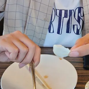 A piece of egg shell a little larger than a quarter found inside Deluex Meshi.