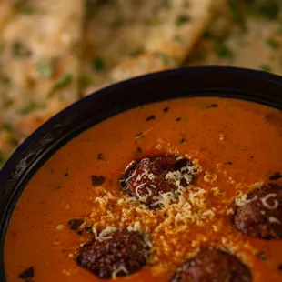 a bowl of soup with bread