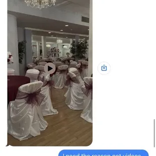 a screenshot of a room with chairs and a chandelier