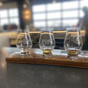 three glasses of whiskey on a bar