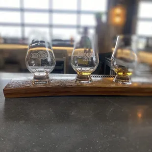 three glasses on a wooden tray