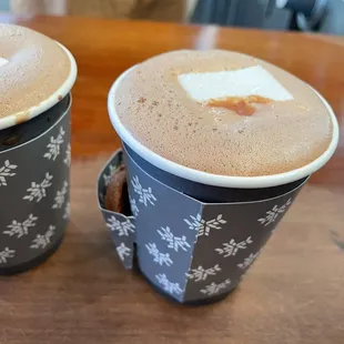 Hot chocolate with delicious marshmallow and cookie in a side car.
