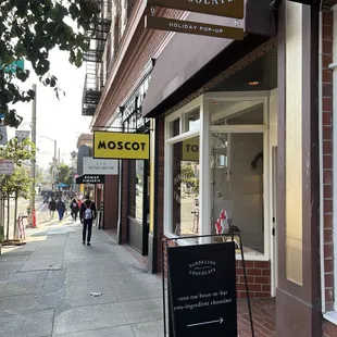 a sidewalk in front of a chocolate shop