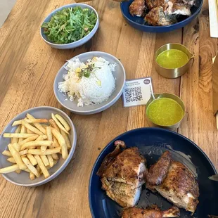 1/2 Chicken with Sides (French Fries, Rice and Arugula Salad) and Peruvian inspired flavor (the green sauce).