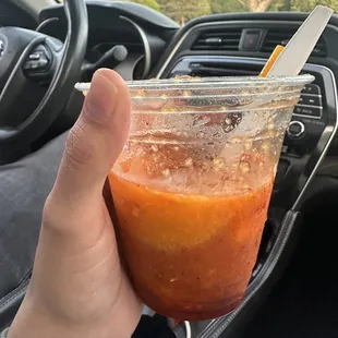 a hand holding a cup of ice cream