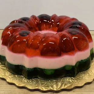 Gelatina with green grapes in the bottom layer. Strawberries and cherry&apos;s in the top layer.