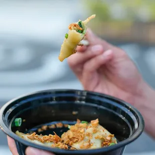 a person holding a bowl of food