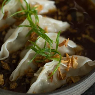 a bowl of dumplings with meat and vegetables