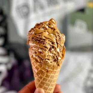 Vanilla soft serve  topped with Reese&apos;s and cookie butter sauce