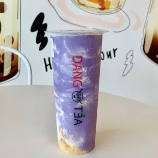 a purple cup with a drink in it