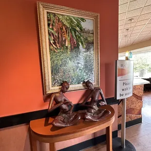 a wooden table with a statue of a woman on it