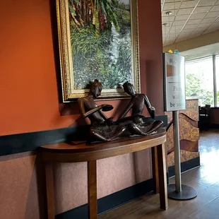 a statue of a woman reading a book