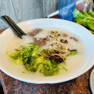 a bowl of soup and a plate of salad