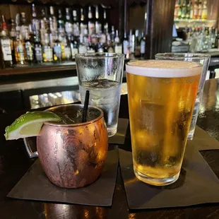 two glasses of beer and a copper mug