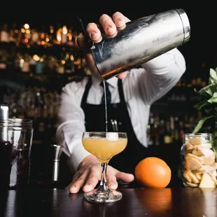 a bartender pouring a drink