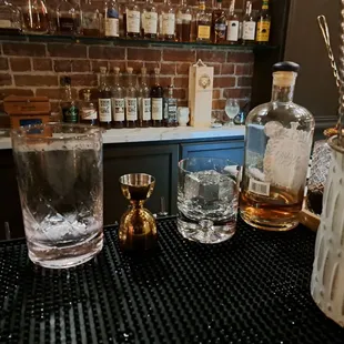 Making a Negroni at the bar. Square ice cube stamped with Daniellos lion logo.