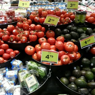 a display of tomatoes and avocados