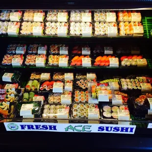 a display of sushi in a grocery store